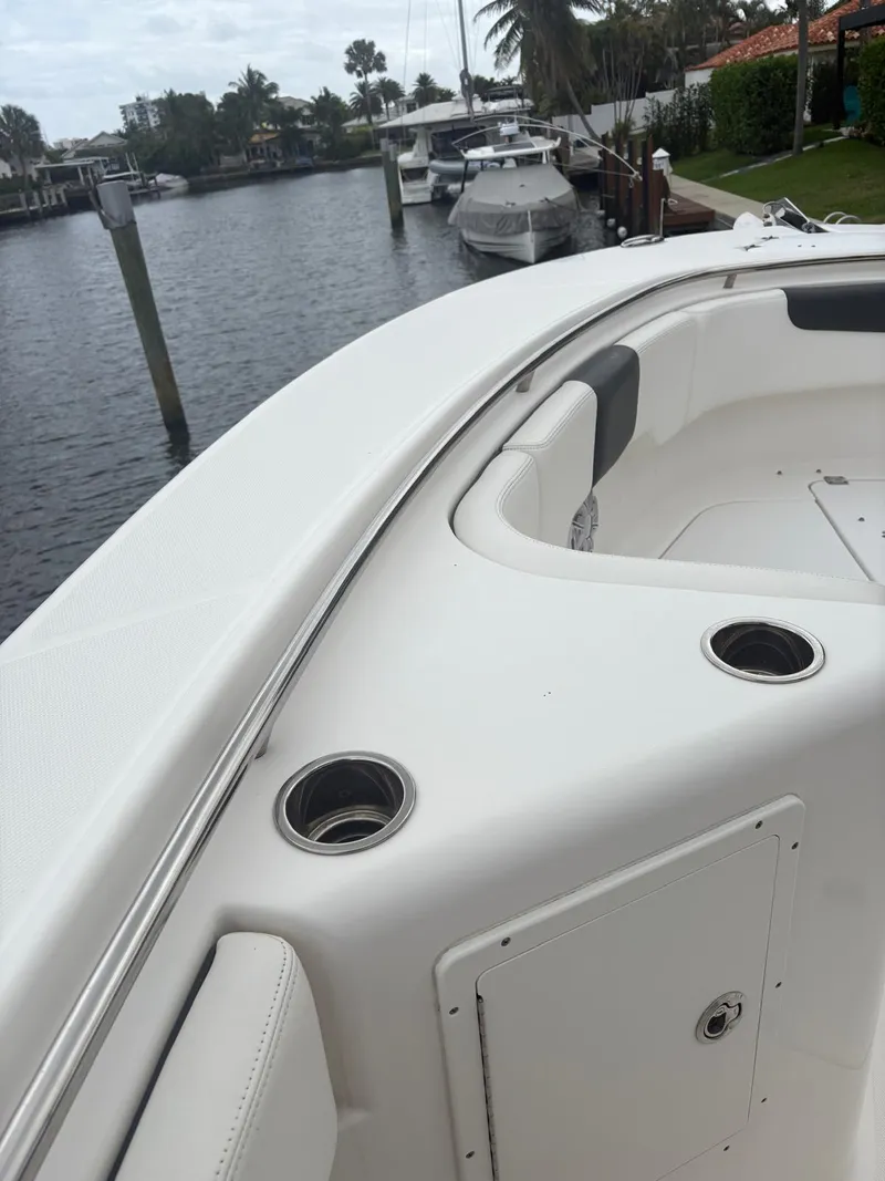 Slide: The Image of 2018 Robalo R302 Center Console boat docked by waterfront homes. - 27