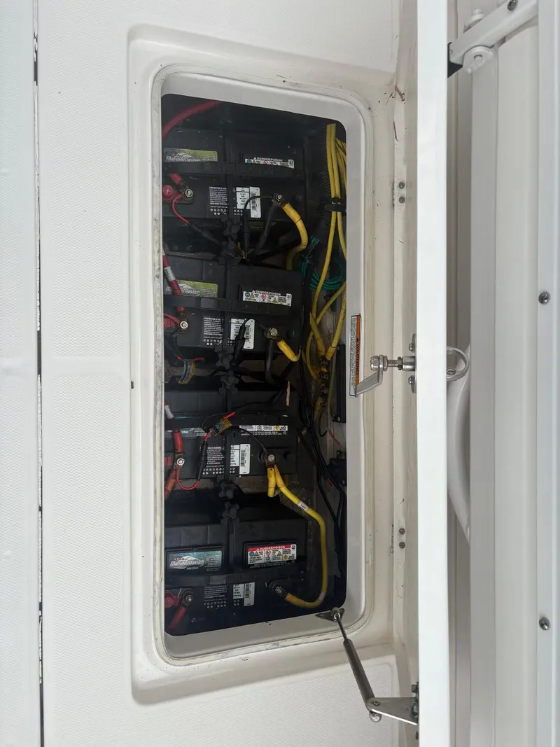 Slide: The Image of 2018 Robalo R302 Center Console battery compartment with multiple batteries and wiring. - 30