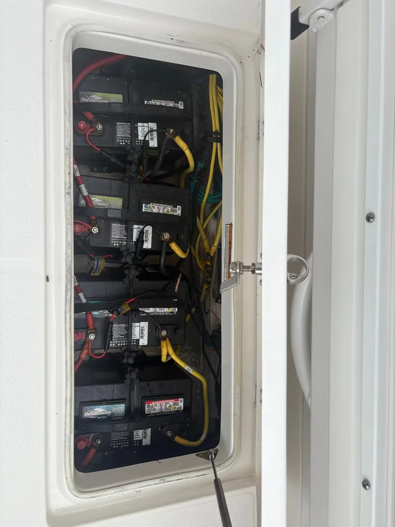 Slide: The Image of Battery compartment of 2018 Robalo R302 Center Console boat, showing multiple connected batteries. - 31