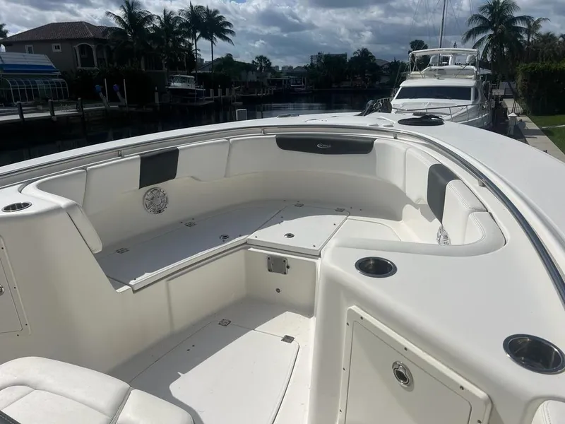 Slide: The Image of 2018 Robalo R302 Center Console boat interior with seating and cup holders. - 9