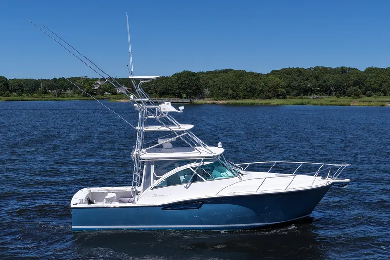 Slide: The Image of 2018 Albemarle 36 Express boat on calm water, clear blue sky background. - 14