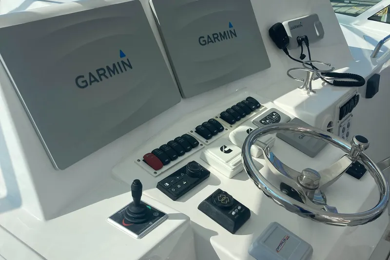 Slide: The Image of Control panel of 2018 Albemarle 36 Express with Garmin displays and steering wheel. - 20