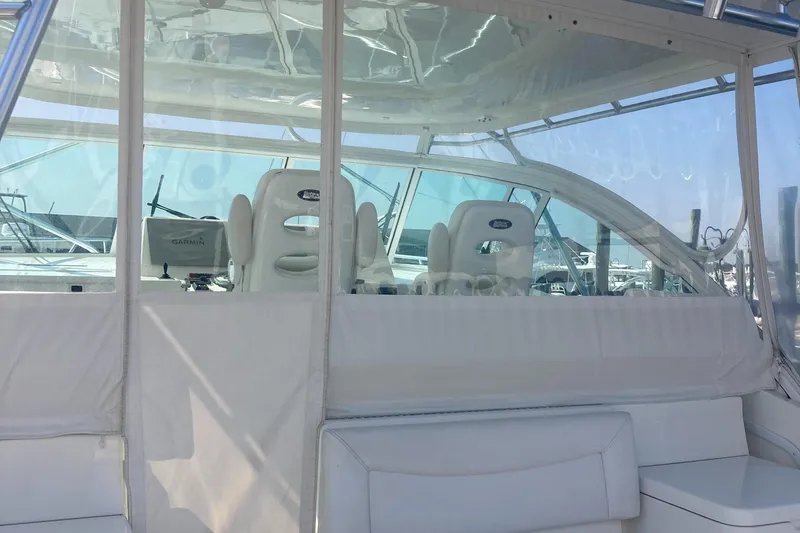 Slide: The Image of 2018 Albemarle 36 Express boat interior with white seating and clear enclosure. - 22