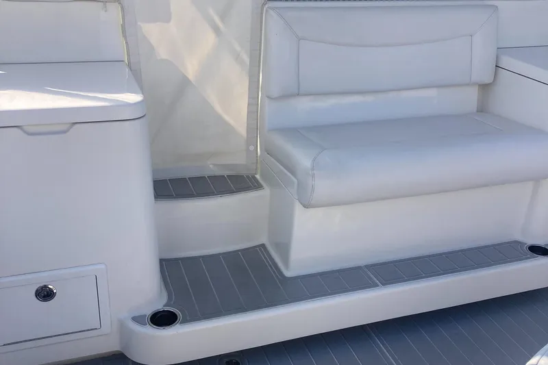 Slide: The Image of 2018 Albemarle 36 Express boat interior with white seating and storage compartments. - 25