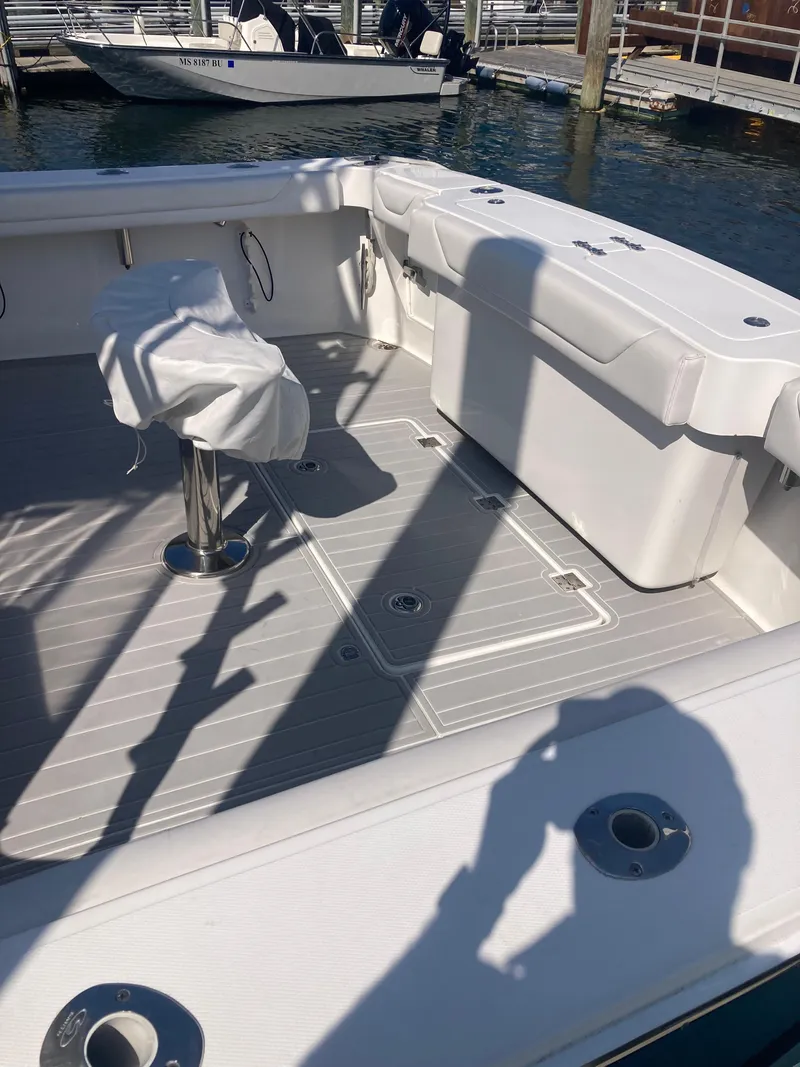 Slide: The Image of 2018 Albemarle 36 Express boat deck with seating and covered chair. - 26
