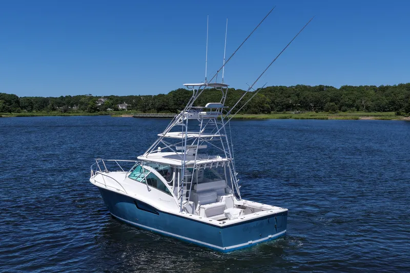 Slide: The Image of 2018 Albemarle 36 Express boat on calm water, surrounded by lush greenery. - 7