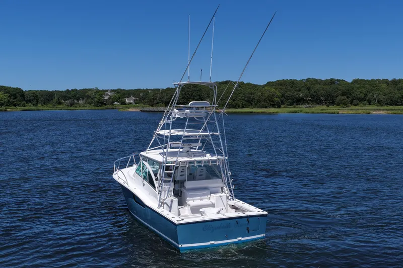 Slide: The Image of 2018 Albemarle 36 Express boat on calm water under clear blue sky. - 8