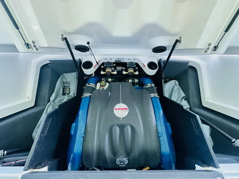 Slide: The Image of 2018 MasterCraft X23 engine compartment with Ilmor engine, showcasing blue hoses and components. - 25