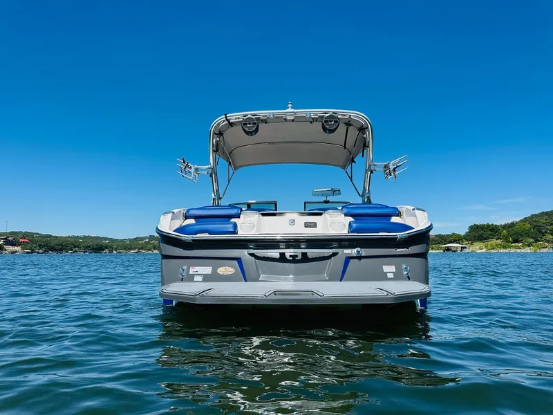 Slide: The Image of 2018 MasterCraft X23 boat on a lake, clear blue sky background. - 4