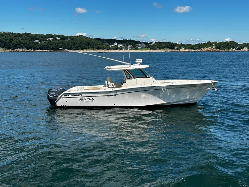 The Image of 2017 Grady-White Canyon 376 boat on calm water, clear sky, scenic background. - 0