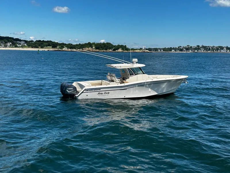 Slide: The Image of 2017 Grady-White Canyon 376 boat on calm blue water, scenic coastal background. - 11