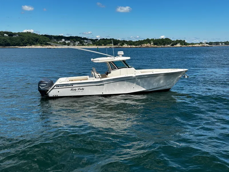Slide: The Image of 2017 Grady-White Canyon 376 boat on calm water, clear sky background. - 12