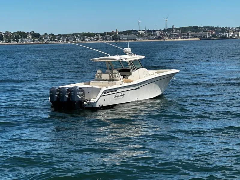 Slide: The Image of 2017 Grady-White Canyon 376 boat on water with coastal town in background. - 2