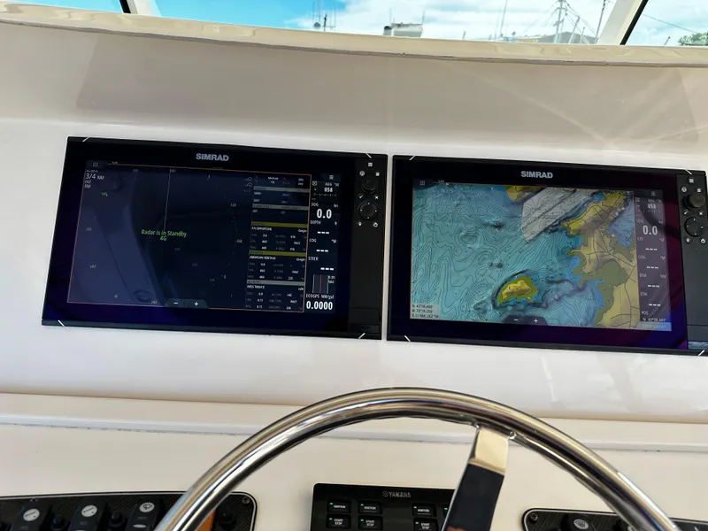 Slide: The Image of Simrad navigation screens on 2017 Grady-White Canyon 376 boat dashboard. - 23