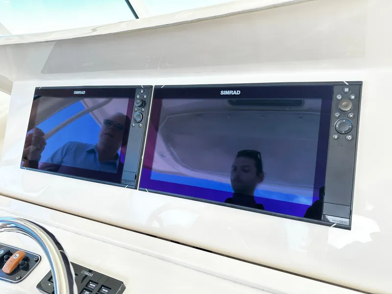 Slide: The Image of Simrad navigation screens on 2017 Grady-White Canyon 376 boat dashboard. - 24