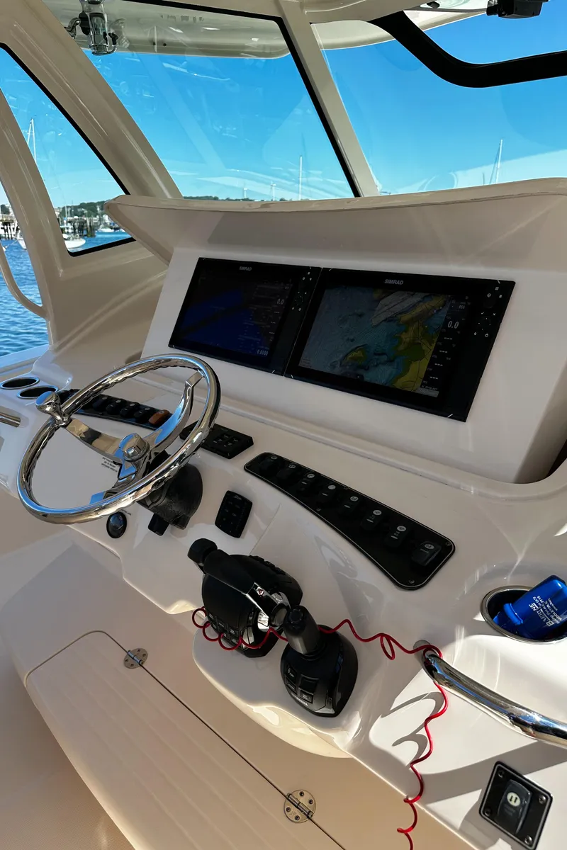 Slide: The Image of 2017 Grady-White Canyon 376 helm with dual navigation screens and steering wheel. - 26