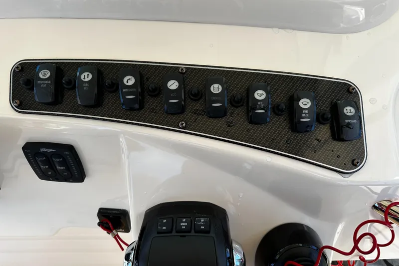 Slide: The Image of Control panel of a 2017 Grady-White Canyon 376 boat with various switches. - 30