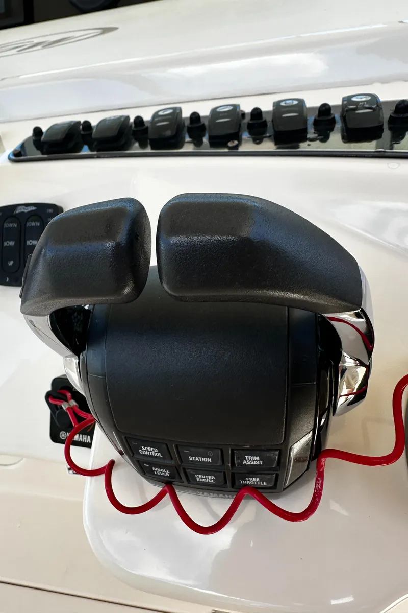 Slide: The Image of Throttle controls on a 2017 Grady-White Canyon 376 boat dashboard. - 32