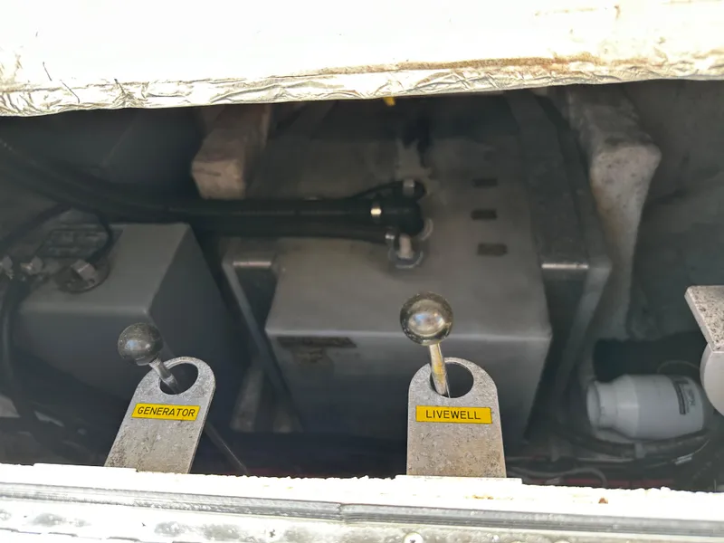 Slide: The Image of Control levers for generator and livewell on a 2017 Grady-White Canyon 376 boat. - 39