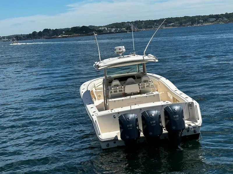 Slide: The Image of 2017 Grady-White Canyon 376 boat with triple Yamaha V8 engines on open water. - 4