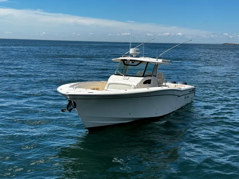 Slide: The Image of 2017 Grady-White Canyon 376 boat on open water under clear blue sky. - 7