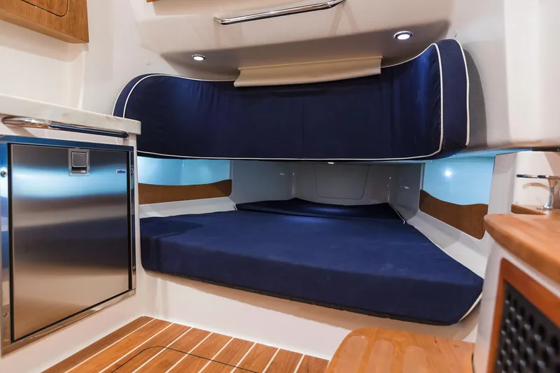 Slide: The Image of Manufacturer Provided Image: 2017 Grady-White Canyon 376 cabin interior with blue cushions and wood accents. - 74