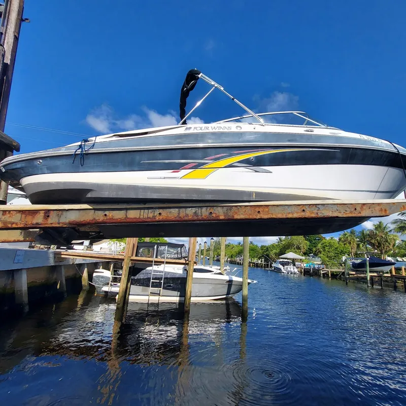 The Image of 2007 Four Winns 240 Horizon boat on lift by waterfront dock. - 0