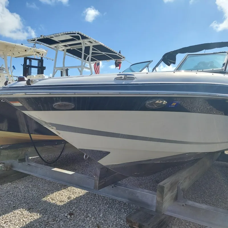 Slide: The Image of 2007 Four Winns 240 Horizon boat on a trailer under a clear blue sky. - 10