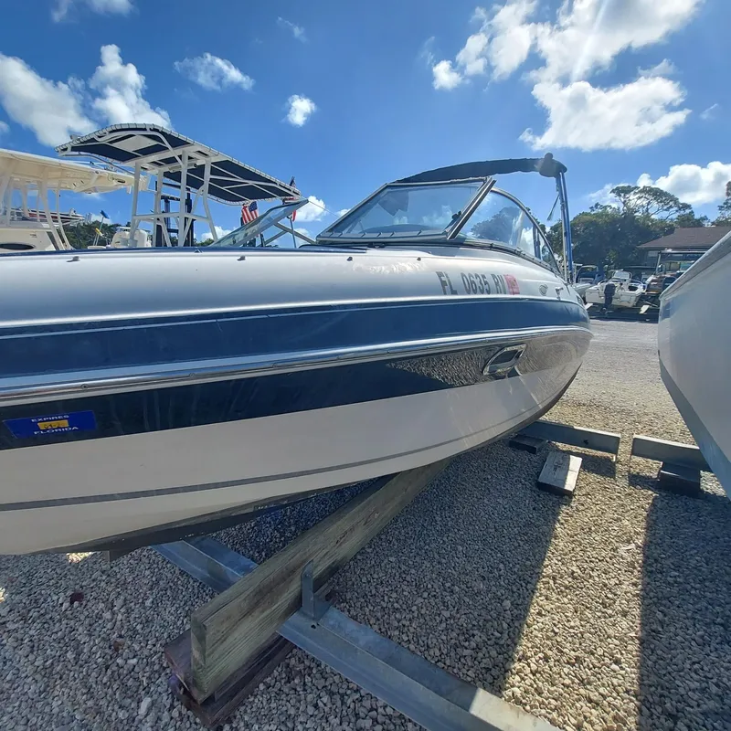 Slide: The Image of 2007 Four Winns 240 Horizon boat on display under a clear blue sky. - 11
