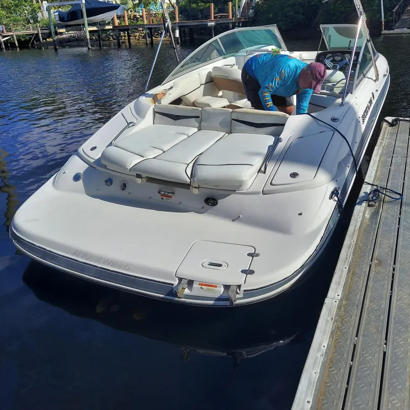 Slide: The Image of 2007 Four Winns 240 Horizon boat docked, person cleaning interior. - 16