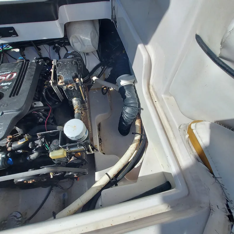 Slide: The Image of Engine compartment of a 2007 Four Winns 240 Horizon boat, showing mechanical components. - 19