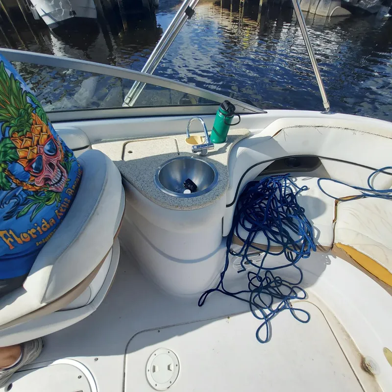 Slide: The Image of 2007 Four Winns 240 Horizon boat interior with sink, ropes, and colorful shirt. - 21