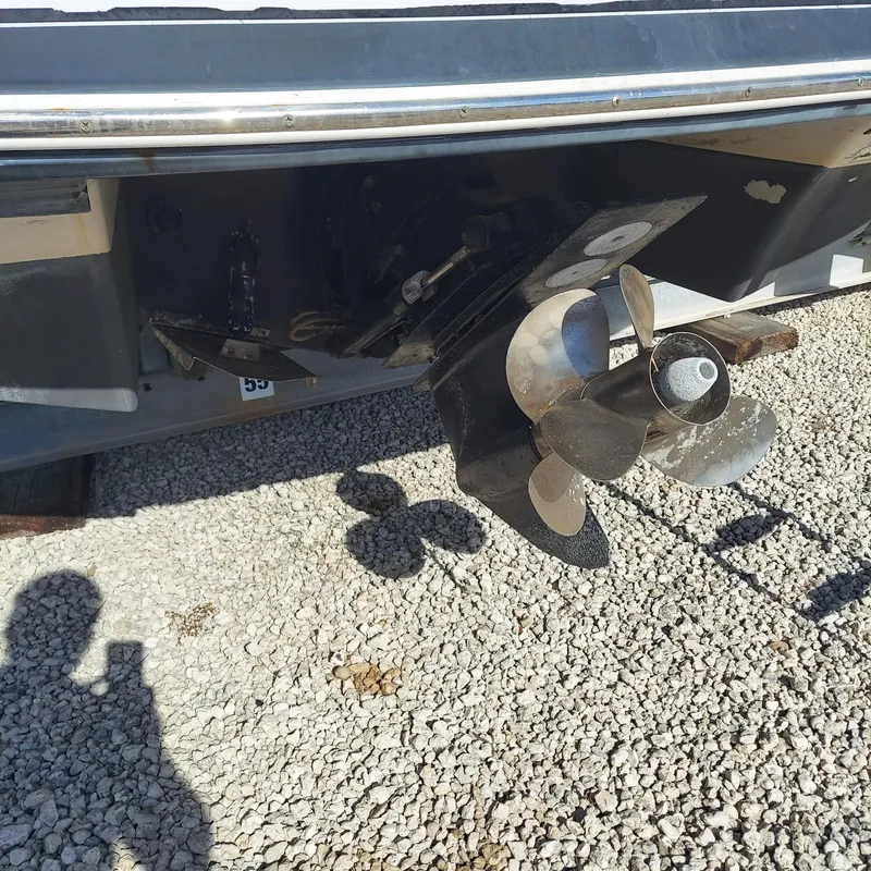 Slide: The Image of 2007 Four Winns 240 Horizon boat propeller on gravel surface. - 5