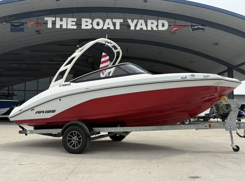 The Image of 2024 Yamaha AR 195 boat with red hull on trailer at The Boat Yard. - 0