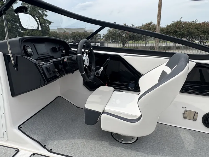 Slide: The Image of 2024 Yamaha Boats AR 195 interior with steering wheel and captain's chair. - 11