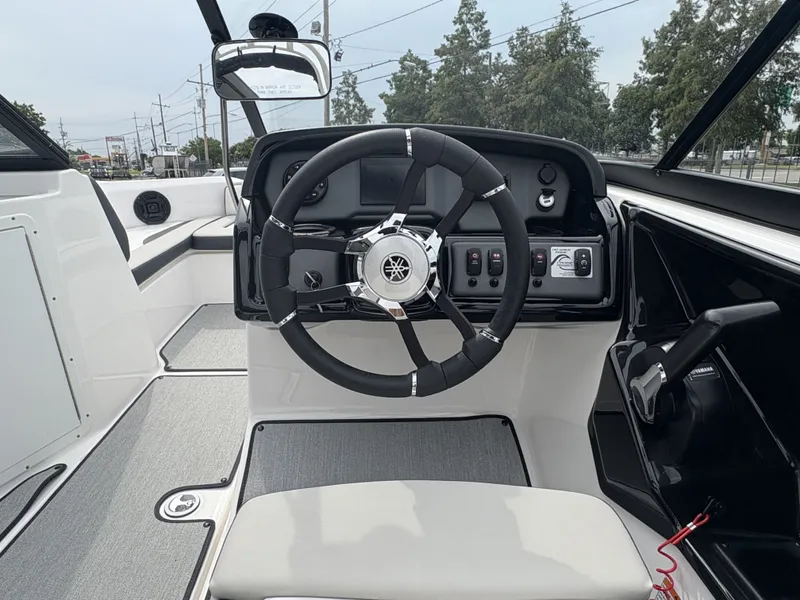 Slide: The Image of 2024 Yamaha Boats AR 195 cockpit with steering wheel and control panel. - 12