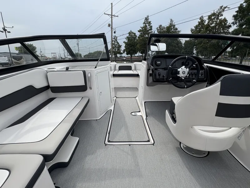 Slide: The Image of 2024 Yamaha Boats AR 195 on trailer, red and white design, parked outdoors. - 2