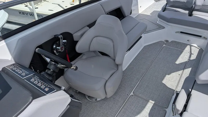 Slide: The Image of 2026 Four Winns H6 OB boat interior with gray seating and control panel. - 12