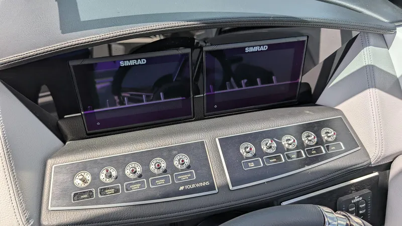 Slide: The Image of 2026 Four Winns H6 OB dashboard with dual Simrad displays and control panel. - 21