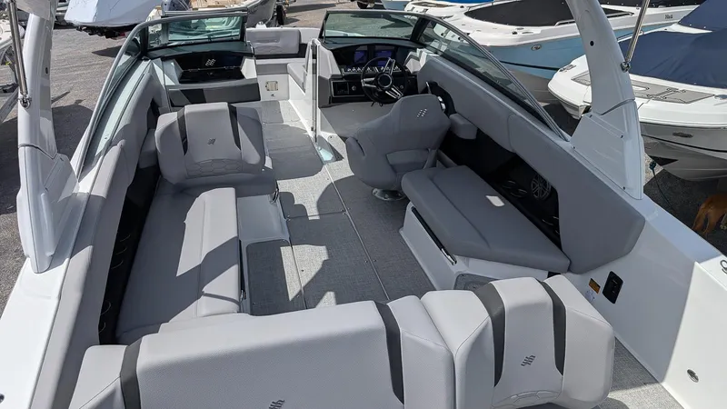 Slide: The Image of 2026 Four Winns H6 OB boat interior with sleek gray seating and modern dashboard. - 8
