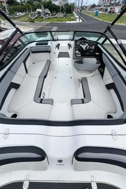 Slide: The Image of 2013 Yamaha Boats 212X interior with spacious seating and modern dashboard. - 10
