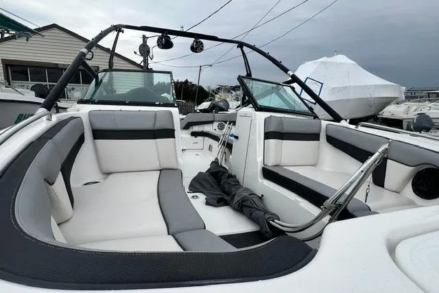 Slide: The Image of 2013 Yamaha Boats 212X interior with white and gray seating, open bow design. - 15