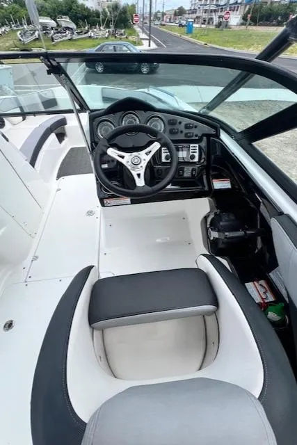 Slide: The Image of 2013 Yamaha Boats 212X cockpit with steering wheel and dashboard controls. - 4