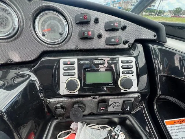 Slide: The Image of Dashboard of a 2013 Yamaha Boats 212X, featuring controls and a Clarion audio system. - 5