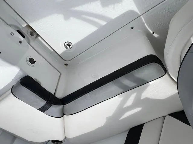 Slide: The Image of Interior seating of a 2013 Yamaha Boats 212X, featuring white and black upholstery. - 7