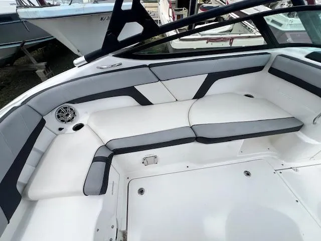 Slide: The Image of 2013 Yamaha Boats 212X interior seating with gray and white upholstery. - 9
