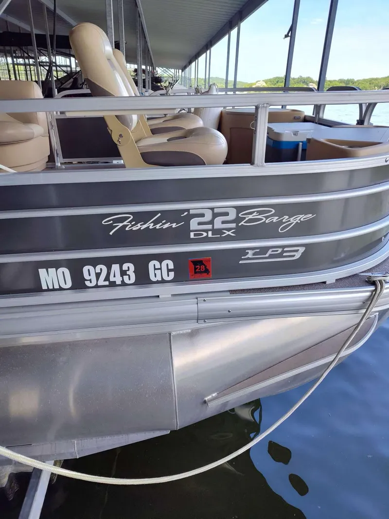 Slide: The Image of 2016 Sun Tracker Fishin' Barge 22 DLX pontoon boat docked, showing registration number. - 5