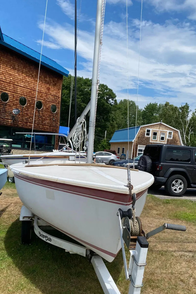Slide: The Image of 1986 Catalina CAPRI 14.2 sailboat on trailer, parked outdoors near buildings. - 3