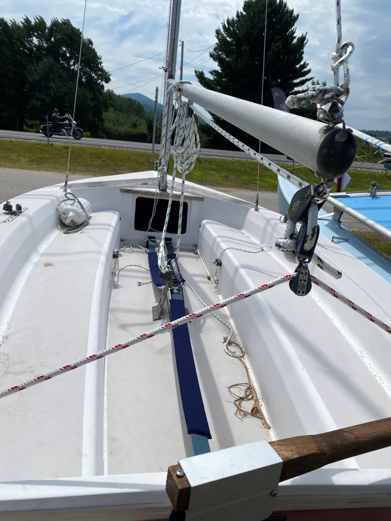 Slide: The Image of 1986 Catalina CAPRI 14.2 sailboat interior with rigging and ropes, parked outdoors. - 6