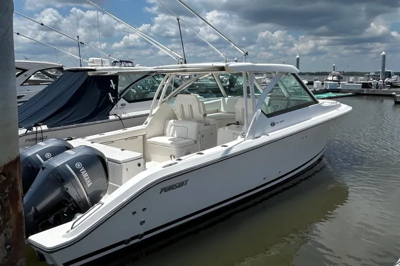 The Image of 2015 Pursuit DC 325 Dual Console boat docked with Yamaha engines. - 0